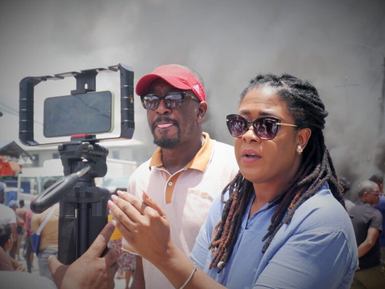 Fmr Shadow Minister of Foreign Affairs and International Trade and FGM Presidential Candidate Amanza Walton-Desir (in blue shirt) engaging the press on the death of 11-year-old Arianna Younge