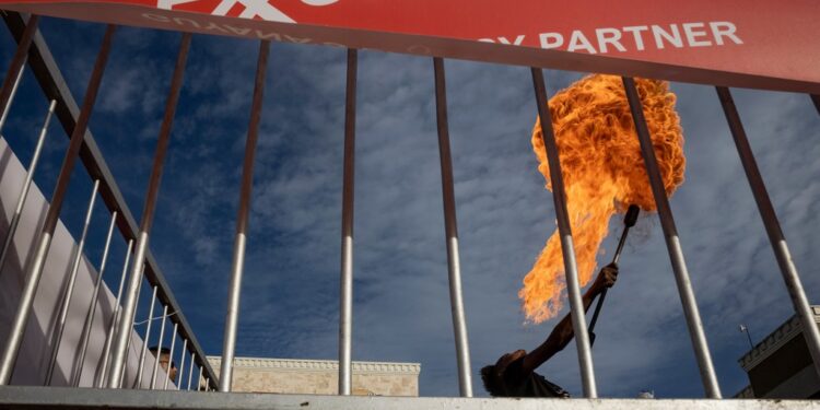 A fire-spitter performs at an ExxonMobil event at a shopping mall in Georgetown, the capital of Guyana.

Photo: Victor Moriyama/InfoAmazonia