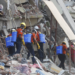 Members of a Myanmar rescue team spray water at the collapsed Sky Villa in Mandalay, Myanmar, March 31, 2025. /VCG