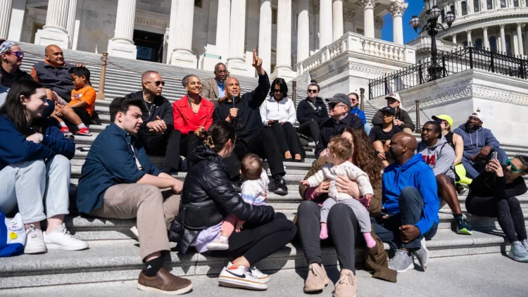 From left, House Minority Leader Hakeem Jeffries, D-N.Y., Maya Wiley, president of the Leadership Conference on Civil and Human Rights, and Sen. Cory Booker, D-N.J., conduct a live-streamed conversation with Americans focused on "our common values, our faith traditions and the moral moment facing our nation," on the House steps of the U.S. Capitol on Sunday, April 27, 2025. Tom Williams/CQ-Roll Call, Inc./Getty Images