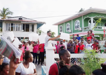 A group of PPP protesters outside of a meeting being held by Azzuddin Mohamed (Stabroek News photo)