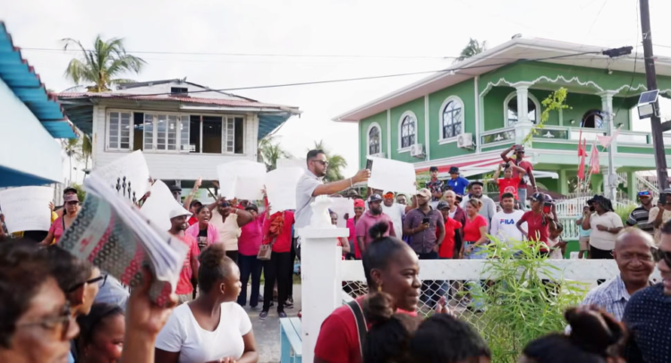 A group of PPP protesters outside of a meeting being held by Azzuddin Mohamed (Stabroek News photo)