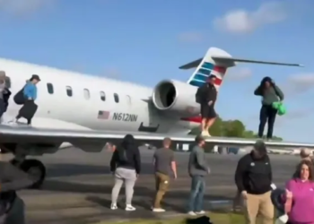 Passengers are seen evacuating American Eagle Flight 5406 after it landed on Tuesday, April 1 at Augusta Regional Airport in Georgia. (APTN/Sean O'Conor)