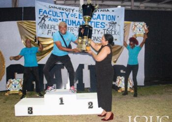 Vice-Chancellor Professor Paloma Mohamed Martin hands over the trophy to the winners from the Faculty of Education and Humanities, on the second day of the University’s Inter-Faculty Track and Field Championships