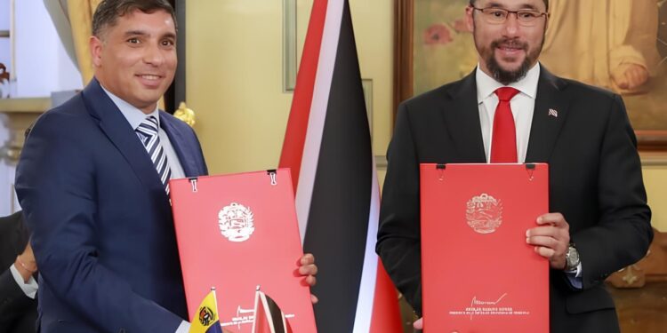 FLASHBACK: Venezuelan Oil Minister Pedro Tellechea, left; and then Energy Minister, now, PM Stuart Young, at the signing ceremony for the Dragon Gas field licence in Caracas, Venezuela in December 2023. -