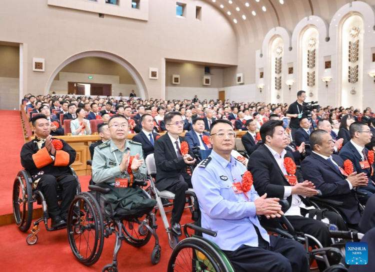A gathering to commend role models with disabilities and people who have made outstanding contributions in helping those with disabilities is held in Beijing, capital of China, May 16, 2025. A total of 200 role models with disabilities, along with 200 outstanding units and 60 exceptional individuals supporting disability services, were honored at the gathering. (Xinhua/Gao Jie)