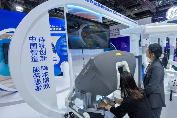 A visitor tries a surgery robot at the booth of Fosunpharma at the Medical Equipment & Healthcare Products Exhibition Area during the 7th China International Import Expo (CIIE) in east China's Shanghai, Nov. 8, 2024. (Xinhua/Zhang Cheng)