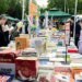 People visit a stall at a book fair in Beijing, capital of China, May 1, 2025. /VCG