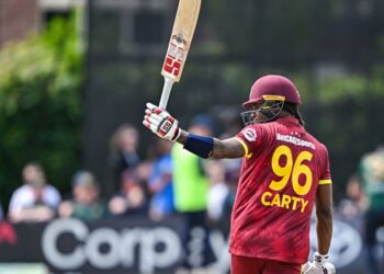 Keacy Carty raises his bat after scoring 100 in 2nd ODI v Ireland