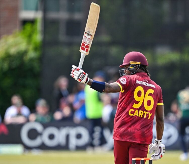 Keacy Carty raises his bat after scoring 100 in 2nd ODI v Ireland