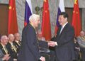 President Xi Jinping shakes hands with a Russian veteran in Moscow, Russia, on May 8, 2015. ZHANG DUO/XINHUA