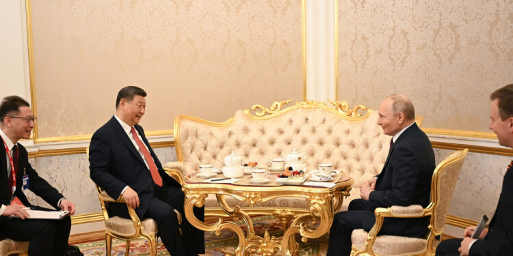 President Xi Jinping and Russian President Vladimir Putin have a chat over tea in Moscow on Thursday. XIE HUANCHI/XINHUA