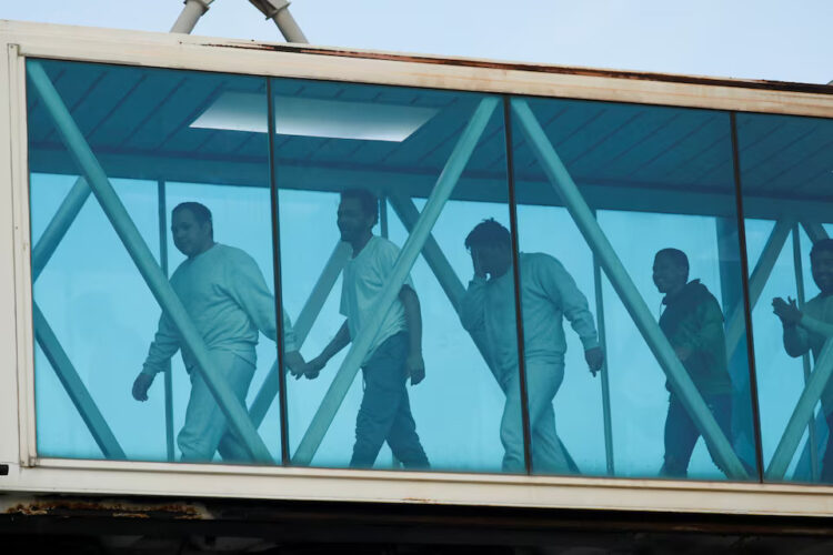 Venezuelan migrants react after arriving on a deportation flight from the United States at Simon Bolivar International Airport, in Maiquetia, Venezuela May 9, 2025. REUTERS/Leonardo Fernandez Viloria/File Photo Purchase Licensing Rights