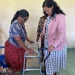 Minister of Human Service and Social Security, Dr Vindhya Persaud, hands over a walker to Hemwattie Ramlall