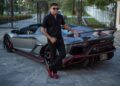 Azruddin Mohamed poses next to his Lamborghini