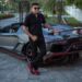Azruddin Mohamed poses next to his Lamborghini