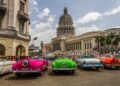 Classic cars that serve as tourist taxis line up in front of the National Capitol Building, or El Capitolio, in downtown Havana. Photo by Frank Carlson (PBS)