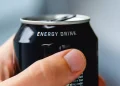 Stock image of someone holding an energy drink.
Getty
