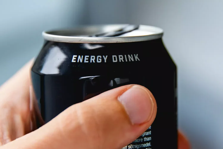 Stock image of someone holding an energy drink.
Getty