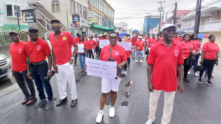 GTUC Organising Secty Eon Andrews (third from left) and GTUC President Norris Witter (far right)