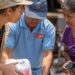 UNFPA Myanmar A UNFPA staff member distributes relief supplies to a woman affected by the March earthquakes in Myanmar.