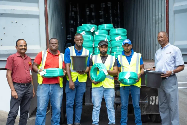 Packed and ready to go. (L-R) Production Manager, Chockalingam Ramasamy; Warehouse Attendants, Krachike Lyn, Shaquile Drummond, Prince Ellis and Phillip Lyons; and Warehouse Manager, Daniel Chambers, prepare the first shipment of Omni’s products to Guyana.