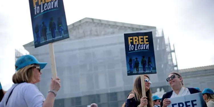 Supporters hold signs as they gather outside the U.S. Supreme Court on April 30, 2025, in Washington. Alex Wong/Getty Images
