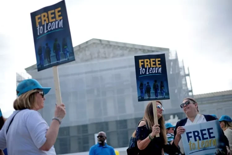 Supporters hold signs as they gather outside the U.S. Supreme Court on April 30, 2025, in Washington. Alex Wong/Getty Images