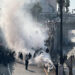 Police officers are enveloped in a cloud of smoke from tear gas and percussion grenades while guarding a highway onramp during a protest against federal immigration sweeps in downtown Los Angeles, California, June 8. REUTERS/Omar Younis