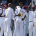Teammates congratulare West Indies' Alzarri Joseph after he dismissed Australia's Usman Khawaja on day two of the first cricket Test match at Kensington Stadium in Bridgetown, Barbados, Thursday, June 26, 2025. (AP Photo/Ricardo Mazalan)