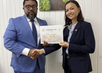 Director of Local Content Secretariat, Dr. Martin Pertab hands over Letter of Approval to MODEC Corporate Manager, Kim Huynh