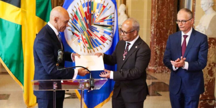 Jamaica’s Ambassador to the United States and Permanent Rep to the OAS, Major Gen. (Rtd) Anthony Anderson presents his credentials to the Secretary General of the OAS, H. E. Albert Ramdin on June 18. At left is Assistant Secretary General , Amb Nestor Mendez. | Derrick Scott Photo.