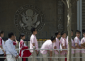 Chinese students wait outside the U.S. Embassy for their visa application interviews, in Beijing on May 2, 2012. Alexander F. Yuan/AP