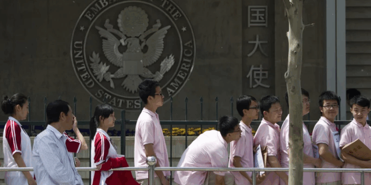 Chinese students wait outside the U.S. Embassy for their visa application interviews, in Beijing on May 2, 2012. Alexander F. Yuan/AP