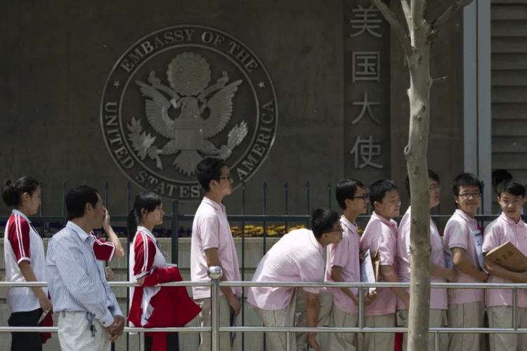 Chinese students wait outside the U.S. Embassy for their visa application interviews, in Beijing on May 2, 2012. Alexander F. Yuan/AP