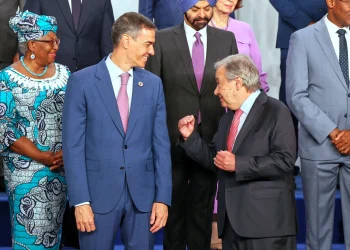 Spain’s Prime Minister Pedro Sanchez, left, speaks with United Nations Secretary-General Antonio Guterres, as they pose for a photo with nation leaders and representatives, at the start of the four-day Financing for Development meeting, in Seville, Spain, Monday, June 30, 2025. (AP Photo/Jose Angel Garcia)