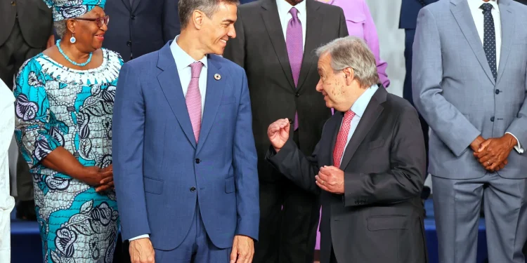 Spain’s Prime Minister Pedro Sanchez, left, speaks with United Nations Secretary-General Antonio Guterres, as they pose for a photo with nation leaders and representatives, at the start of the four-day Financing for Development meeting, in Seville, Spain, Monday, June 30, 2025. (AP Photo/Jose Angel Garcia)