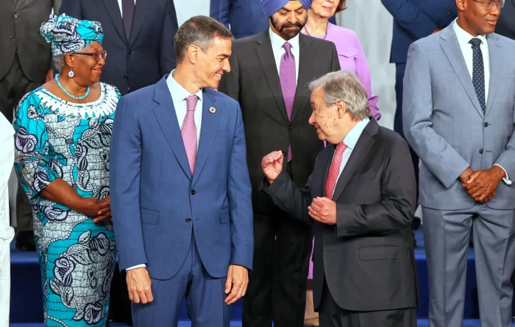 Spain’s Prime Minister Pedro Sanchez, left, speaks with United Nations Secretary-General Antonio Guterres, as they pose for a photo with nation leaders and representatives, at the start of the four-day Financing for Development meeting, in Seville, Spain, Monday, June 30, 2025. (AP Photo/Jose Angel Garcia)