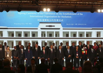 Chinese Foreign Minister Wang Yi, Center, attends the signing ceremony of the "Convention of the Establishment of the International Organization of Mediation", in Hong Kong, Friday May 30, 2025 (AP Photo/Johnathon Lee)