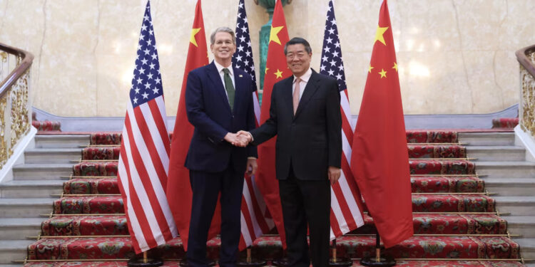 Chinese Vice Premier He Lifeng shakes hands with US Treasury Secretary Scott Bessent in London on Monday. Li Ying/Xinhua/Getty Images