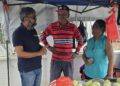Fmr Major Pt. Ubraj Narine (l) engaging Barbicans in the Port Mourant Market