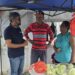Fmr Major Pt. Ubraj Narine (l) engaging Barbicans in the Port Mourant Market
