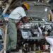 Two workers assemble a car at a manufacturing facility at Gurgaon, Haryana in India. Filephoto: VCG