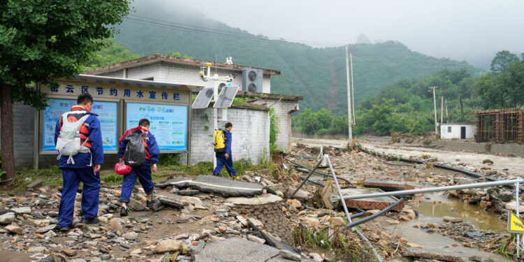 Firefighters head towards Huangyukou village, where communication networks are disrupted, in Miyun district, Beijing, July 27, 2025. [Photo/Xinhua]