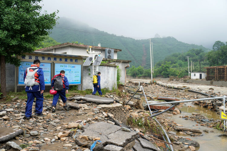 Firefighters head towards Huangyukou village, where communication networks are disrupted, in Miyun district, Beijing, July 27, 2025. [Photo/Xinhua]