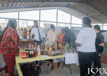 Ann Baker, first left, showcases one of her products to Dr. Ritesh Tularam, Deputy Chief Education Officer (Technical), at the UGIRIE Exhibition of Innovation, Research, and Entrepreneurship.