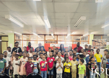 Third from left: Courts Optical Chain Manager, Mr. Richard Simpson; UG Vice-Chancellor, Professor Paloma Mohamed Martin; Managing Director of Unicomer Guyana, Ms. Gillian Matthews; UG’s Chief Librarian, Ms. Debra Lowe; along with other staff of the University of Guyana and Unicomer, and children participating in this year’s Reading is Fun programme.