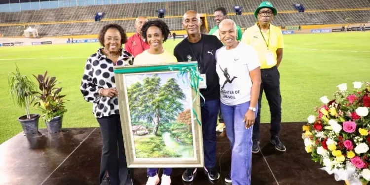 Sprint great Shelly-Ann Fraser-Pryce (second left) is joined by Minister of Sport Olivia Grange (left), JAAA president Garth Gayle (third left), and Wolmer’s High School for Girls principal Colleen Montague during a tribute following her third-place finish in the women’s 100m final at the Jamaica Trials on Friday, marking her final appearance at the national championships. She has already indicated that 2025 will be her final season. (PHOTO: Marlon Reid).