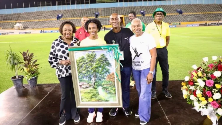 Sprint great Shelly-Ann Fraser-Pryce (second left) is joined by Minister of Sport Olivia Grange (left), JAAA president Garth Gayle (third left), and Wolmer’s High School for Girls principal Colleen Montague during a tribute following her third-place finish in the women’s 100m final at the Jamaica Trials on Friday, marking her final appearance at the national championships. She has already indicated that 2025 will be her final season. (PHOTO: Marlon Reid).