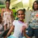 © UNICEF/Roger LeMoyne A young girl shows off her dress in front of her family at home on the island of Antigua, in the Caribbean.